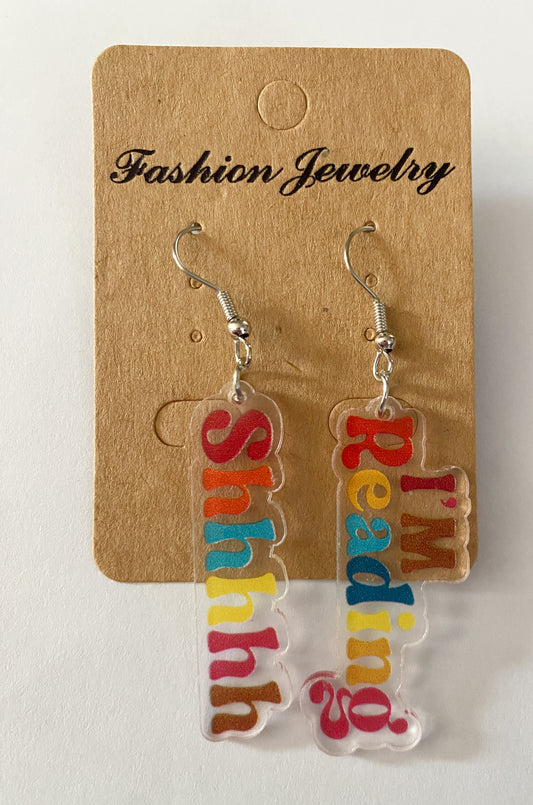 Acrylic earrings one says Shhhhhh the other says I'm reading